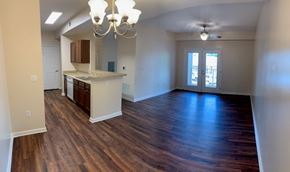 Albany apartment for rent - an empty living room and kitchen with wood flooring