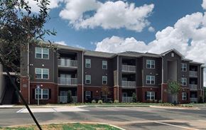 Albany apartment for rent - an apartment building with an empty parking lot