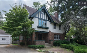 Ann Arbor apartment for rent - the front of a house with a driveway and trees