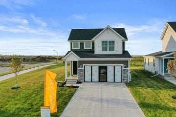 Waukee house for rent - a house with a sidewalk in front of it and a sign on the sidewalk