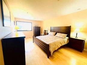 Austin apartment for rent - a bedroom with a bed and a dresser and a window