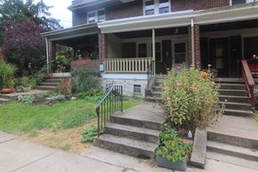 Pittsburgh house for rent - the front of a house with stairs and a porch with plants