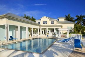Bradenton house for rent - a large swimming pool in front of a large house