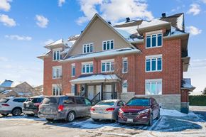 Stittsville apartment for rent - A red brick house with a car parked in front.