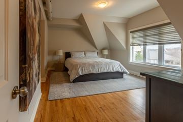 Stittsville apartment for rent - A bedroom with a bed and a rug in the middle of the room.