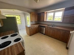 Victoria apartment for rent - an empty kitchen with a stove and a sink