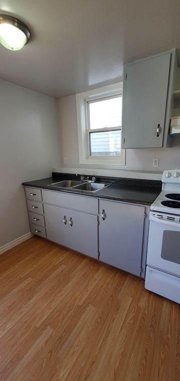 Pictou apartment for rent - A kitchen with white cabinets and a black countertop.
