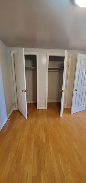 Pictou apartment for rent - an empty bedroom with doors open and wood floors