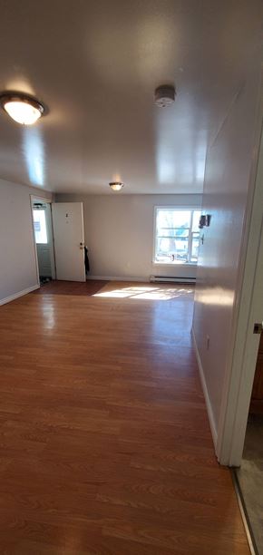Pictou apartment for rent - an empty living room with wood floors and a window