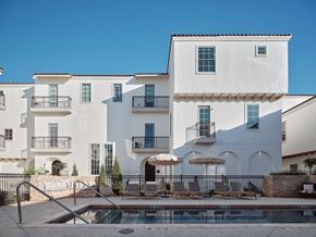 Oklahoma City apartment for rent - A white building with a pool in front.