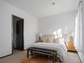 Oklahoma City apartment for rent - A bedroom with a bed, nightstands, and a rug.