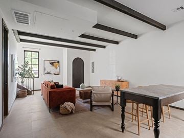 Oklahoma City apartment for rent - A living room with a red couch, a wooden table, and a painting on the wall.