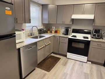 Oxon Hill apartment for rent - A kitchen with a black fridge, white oven, and a sink.