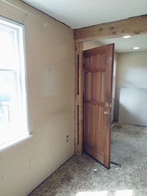Victoria apartment for rent - a bedroom with a wooden door and a window
