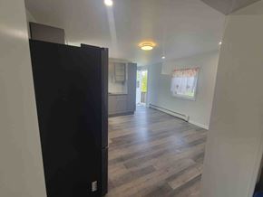 Westville apartment for rent - A black refrigerator is in the corner of a kitchen.