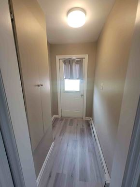 Westville apartment for rent - A hallway with a white door and a window.