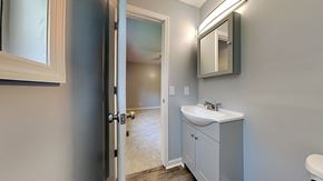 Clarksville house for rent - a bathroom with a sink and a mirror and a doorway