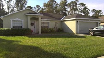 Fort Myers house for rent - A house with a car parked in front of it.