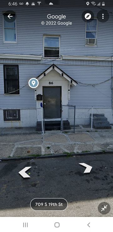 Newark apartment for rent - A blue house with a black door and a window with a curtain.