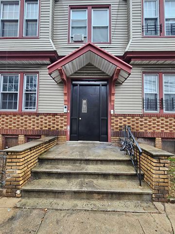 Newark apartment for rent - the front of a house with steps and a black door