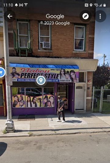 Jersey City apartment for rent - a person standing on the sidewalk in front of a store