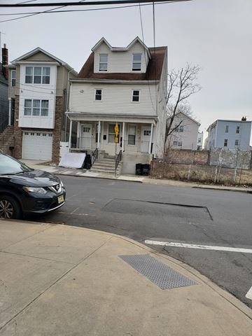Newark apartment for rent - A black car is parked on the side of a street.
