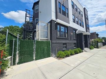 East Orange apartment for rent - an apartment building with a sidewalk and a fence