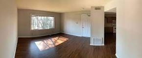 Wood Dale apartment for rent - A room with wooden floors and a large window.
