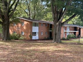 Raleigh apartment for rent - A brick building with the words "Apartments" written on the front.