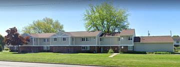 Toledo apartment for rent - a large gray house on the side of a street