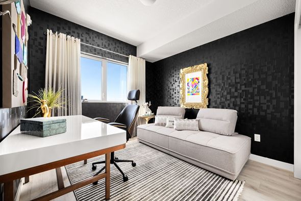 Calgary apartment for rent - A black and white living room with a couch, chair, and a painting on the wall.