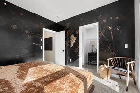 Calgary apartment for rent - A bedroom with a large bed and a chair.