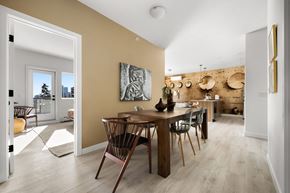 Calgary apartment for rent - A dining room with a wooden table and chairs.