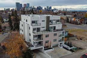 Calgary apartment for rent - A large white apartment building with the words "LIVEATIVOCA" on the side.