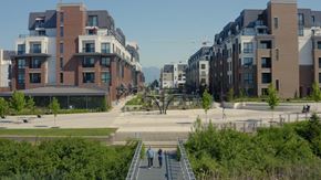 Langley apartment for rent - A modern residential area with apartment buildings and a pedestrian walkway.