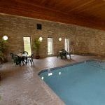 Arden Hills apartment for rent - a swimming pool in a room with a table and chairs