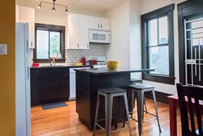 Vancouver apartment for rent - a kitchen with a center island and three bar stools