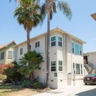 Los Angeles apartment for rent - a house with two palm trees in front of it