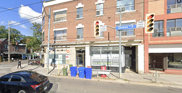 Toronto apartment for rent - a building on the corner of a street with a traffic light