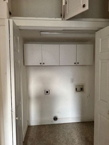 Atlanta apartment for rent - A white kitchen with a cabinet and a door.