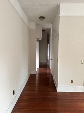 Atlanta apartment for rent - A long hallway with wood floors and white walls.