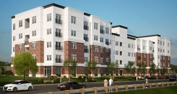 Clarkston apartment for rent - A large white and red building with a tree in front of it.