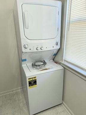 Washington apartment for rent - a dryer sitting on top of a washing machine in a bathroom