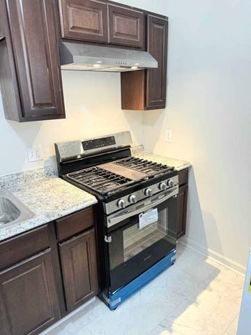 Washington apartment for rent - a kitchen with a stove and a microwave and a sink