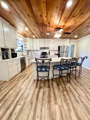Lafayette house for rent - a kitchen with a center island and a table with chairs