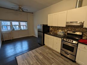 Hamilton apartment for rent - an empty kitchen with stainless steel appliances and white cabinets