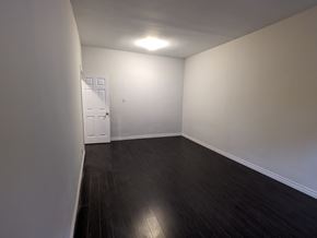 Hamilton apartment for rent - an empty living room with wood floors and white walls