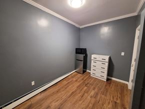 Elizabeth apartment for rent - A kitchen with a refrigerator, microwave, and a white drawer cabinet.