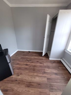 Elizabeth apartment for rent - A room with a wooden floor and a white door.