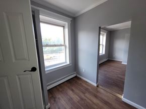 Elizabeth apartment for rent - A room with a white door and a window with a view of the street outside.